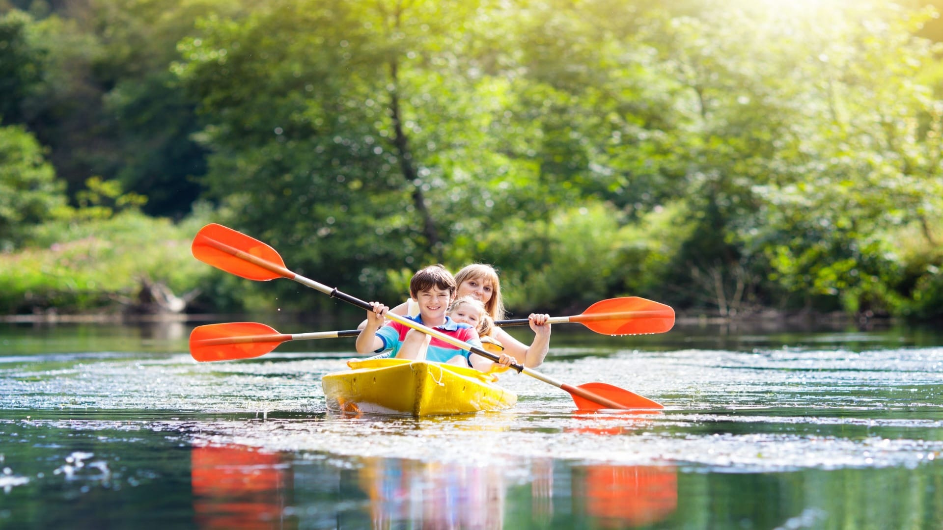 Child on kayak. Kids on canoe. Summer camping