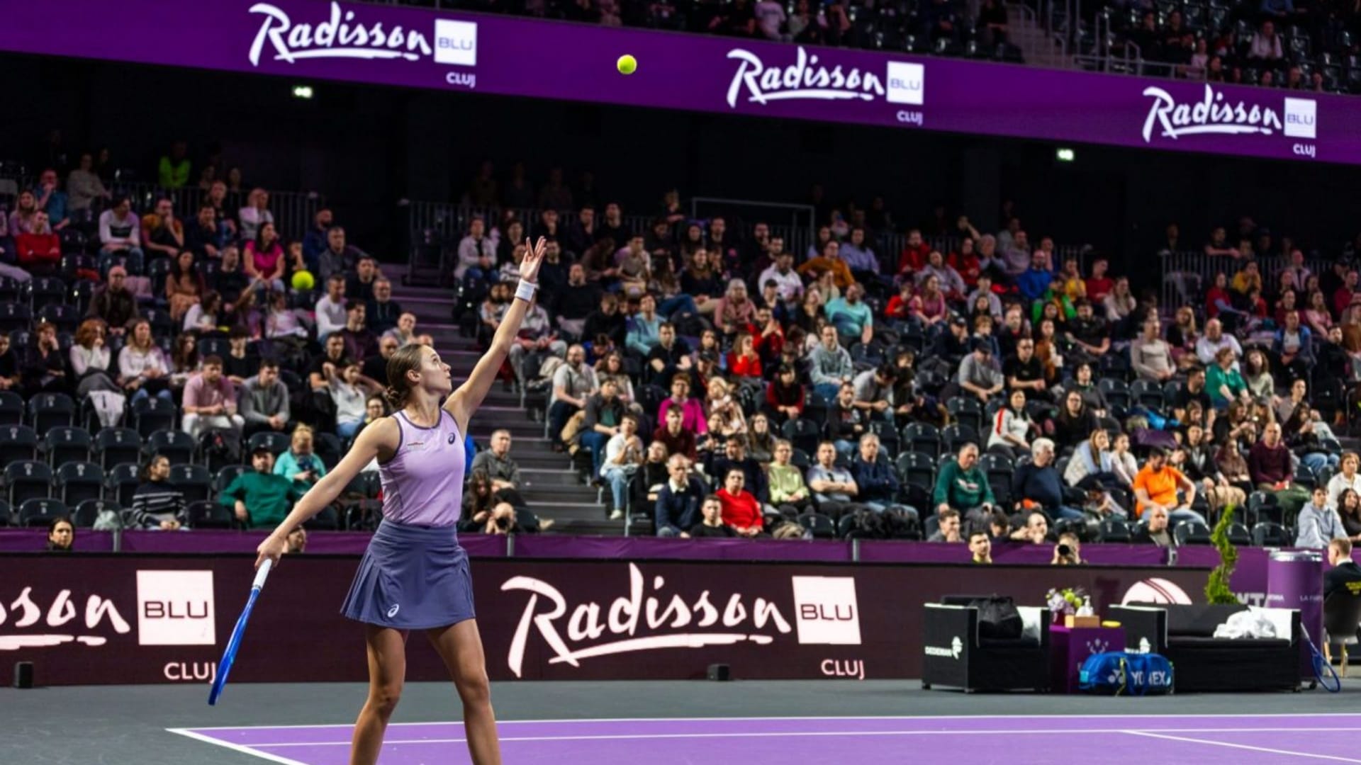 Radisson Hotel luxury tennis courts with professional players competing in a global tournament, surrounded by spectators and event brandin