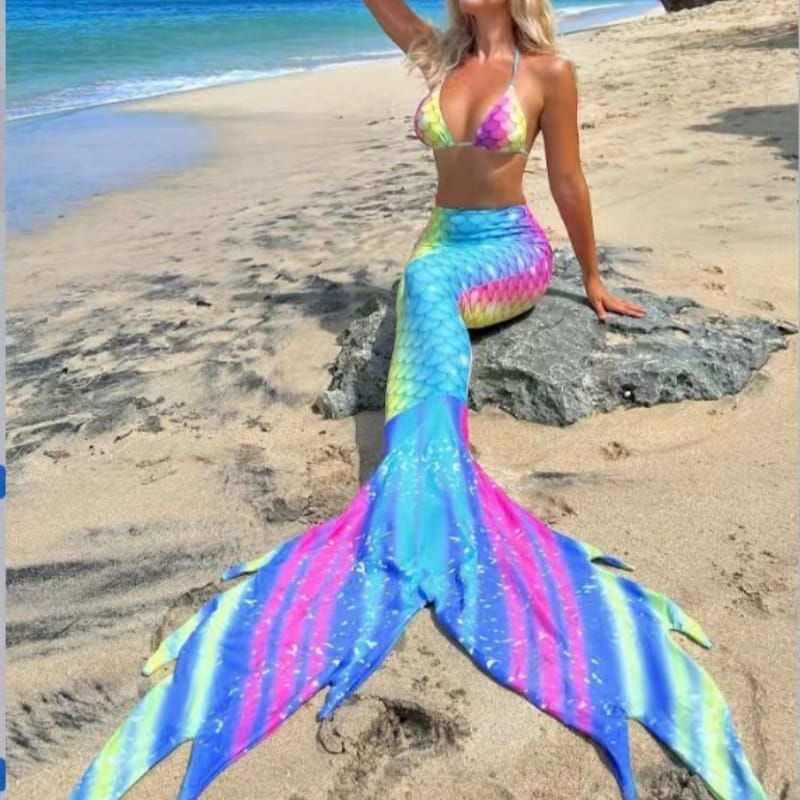 Business professionals mingling in infinity pool with sleek swimmable mermaid tails