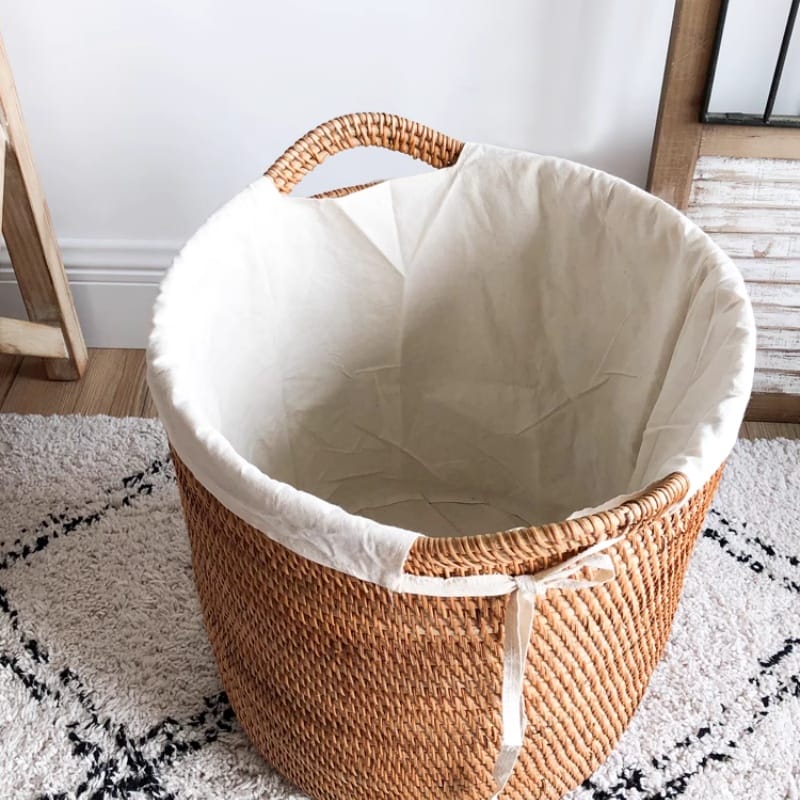 Monogrammed rattan container with gold-thread hotel insignia