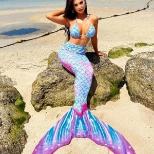 Kids laughing in hotel pool with oversized swimmable mermaid tails, family vacation memories