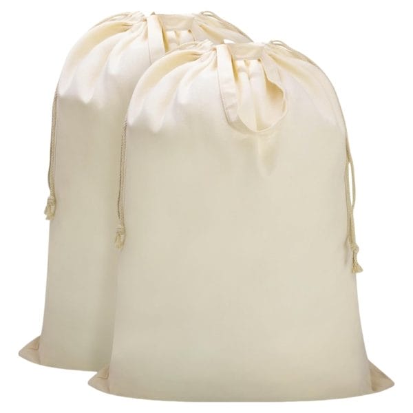 Mini canvas laundry bags (24”x35”) with airline branding, stored in Emirates First Class cabin overhead compartments.