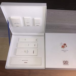 Hotel Amenity Kits in FSC-certified coated paper with gold-thread embroidery, eco-friendly luxury hotel supplies