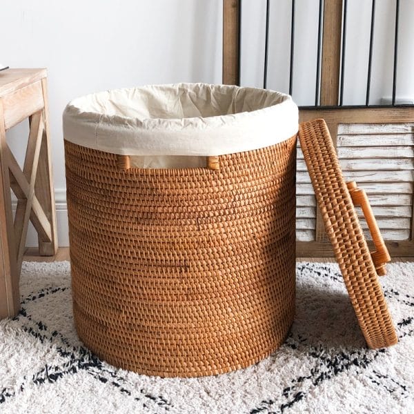 Handwoven rattan laundry basket with waterproof liner, ideal for beachfront hotel laundry rooms