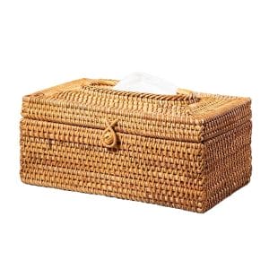 Rustic rattan box holding tissues and hotel amenities, styled in minimalist bedroom decor
