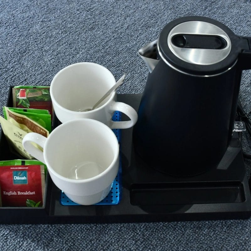 Hotel engineering team servicing electric kettle with spare parts toolkit