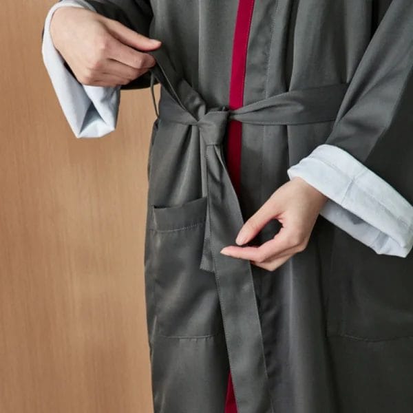 Guest wrapped in Luxury Double Layer Hotel Bathrobe relaxing poolside at five-star resort.