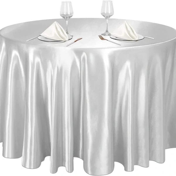 "Sky Grey" DERBAL tablecloth on ocean-view table during sunset, repelling salt spray