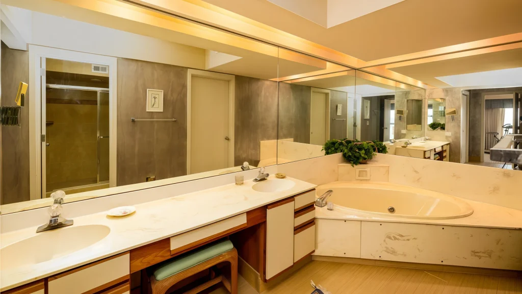 White ceramic basin integrated into a 500mm wall-mounted hotel vanity unit with recessed handles and minimalist design.
