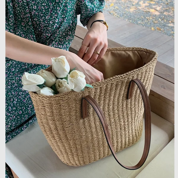 Close-up of the faux leather handles on a Straw Beach Tote Bag for comfortable carrying.