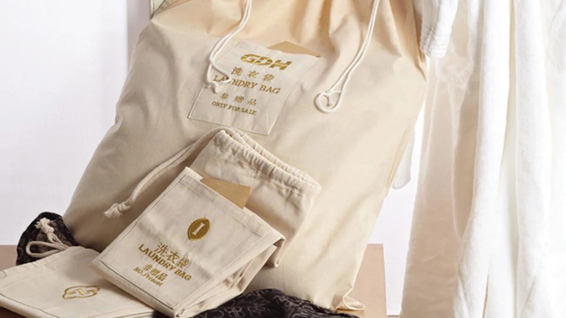 Custom branded hotel laundry bag with hotel logo, eco-friendly fabric, and drawstring closure.