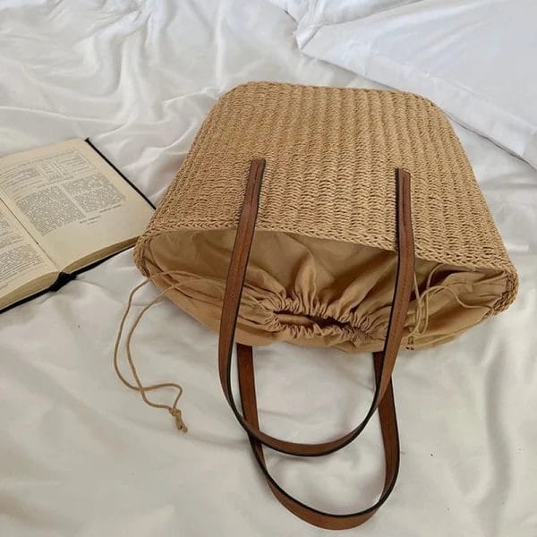 Demonstrating the lightweight portability of the Straw Beach Tote Bag.