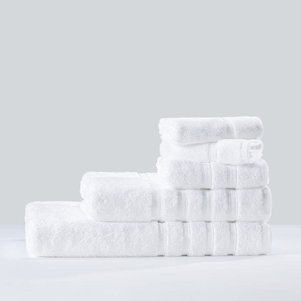 Precision-sized 50x100cm Hotel Bath Towels on bamboo vanity tray at Rosewood Abu Dhabi