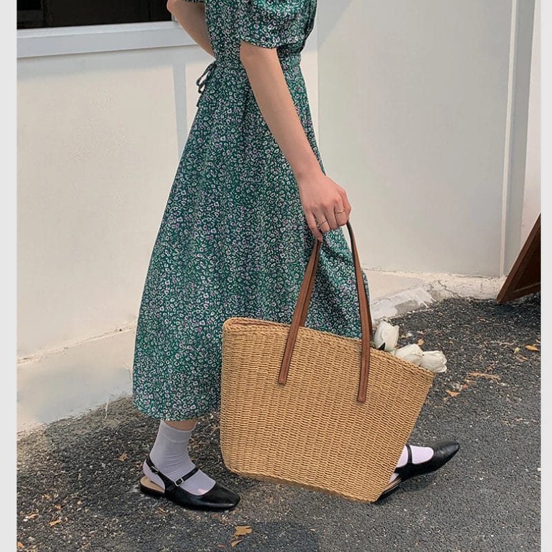 Interior view of the spacious Straw Beach Tote Bag with polyester lining and slip pouch.