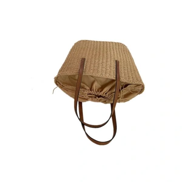 A versatile Straw Beach Tote Bag used in a relaxed beach lifestyle setting.