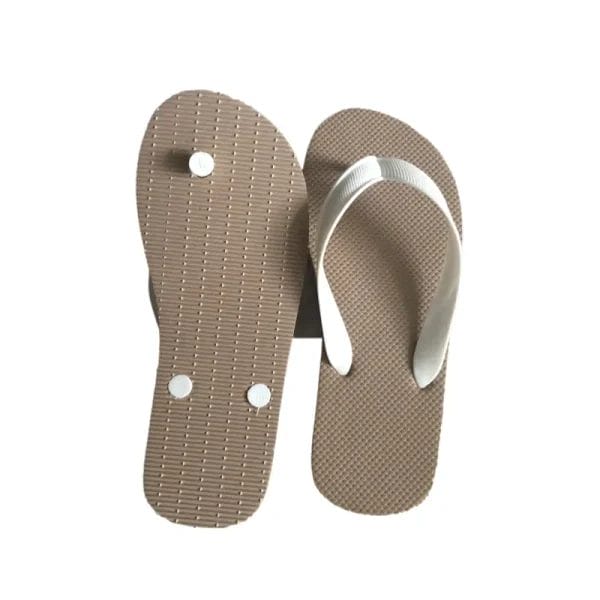 A pair of Outdoor Beach Flip Flops Cheap Slippers neatly presented in a guest room, showcasing their use as a thoughtful hotel amenity.