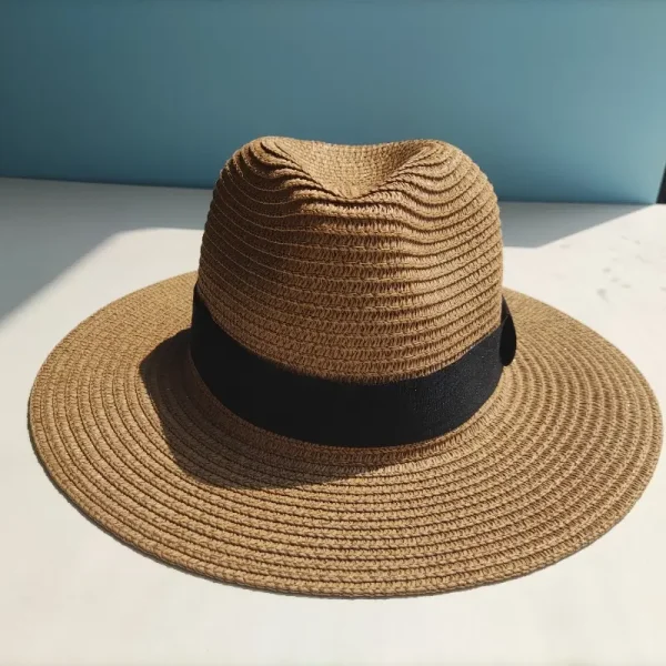 A Panama hat Straw Sun Hat being folded and placed into a bag, showcasing its packable and foldable design.