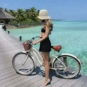A close-up of the luxury front basket on the Coast Beach Bike Island Cruiser, showing its utility for carrying belongings.