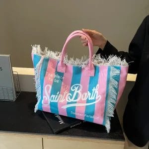 A guest stylishly carrying the branded Hotel cotton canvas Vanity tote bag on their shoulder, demonstrating its use as a fashionable and practical accessory.