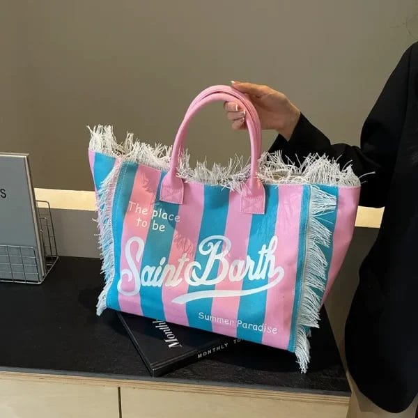 A guest stylishly carrying the branded Hotel cotton canvas Vanity tote bag on their shoulder, demonstrating its use as a fashionable and practical accessory.