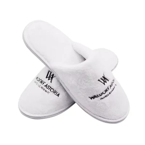 A top-down view highlighting the distinct left and right foot shapes of the anatomic Waldorf Astoria Slippers, a true luxury Hotel Velvet Slipper feature for superior comfort.