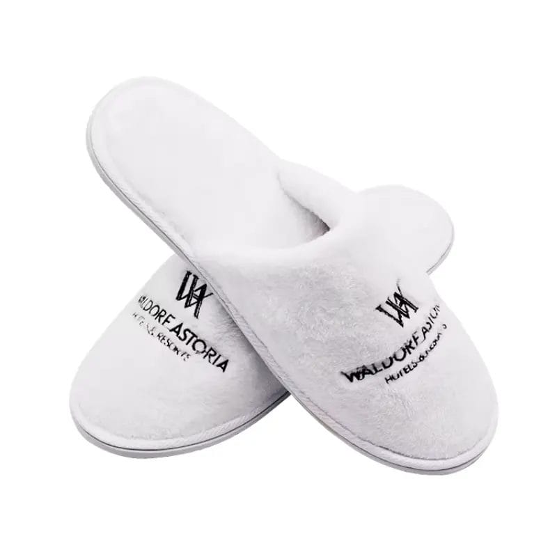 A top-down view highlighting the distinct left and right foot shapes of the anatomic Waldorf Astoria Slippers, a true luxury Hotel Velvet Slipper feature for superior comfort.
