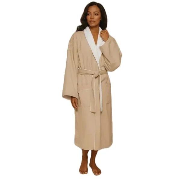 The full-length, beige DERBAL Signature Luxury Hotel Bathrobe hanging elegantly, showcasing its sophisticated shawl collar and refined drape.