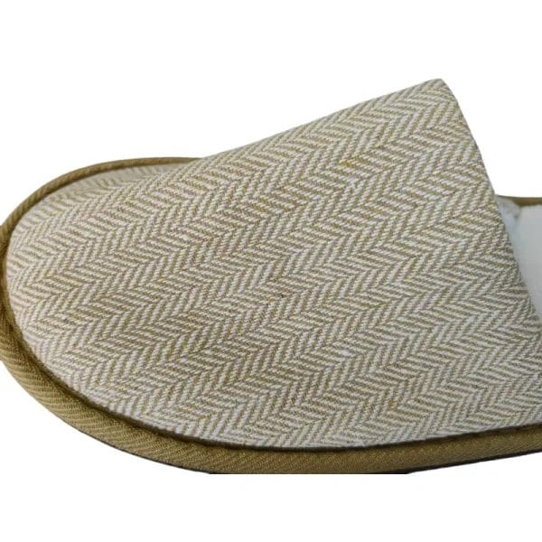 A detailed macro shot focusing on the natural, sustainable cork sole of a Hotel Eco-friendly Slipper, highlighting its unique and earthy texture.