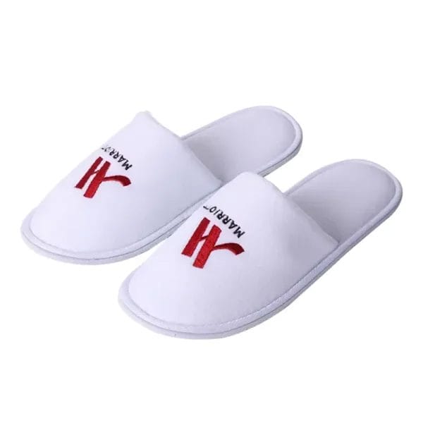 Close-up of a Terry velvet Hotel Slippers showing fine embroidered hotel logo on the strap, highlighting branding options.