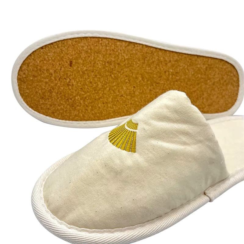 A Cotton Cork Sole Slippers resting on a poolside deck, illustrating its durability and suitability for resort environments.