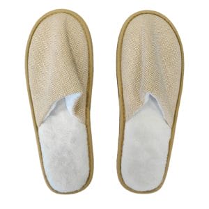 An angled view of a Hotel Eco-friendly Slipper revealing the contrast between its soft, plush fleece interior and the elegant herringbone weave of the upper.