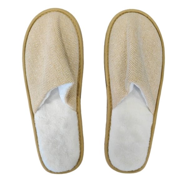 An angled view of a Hotel Eco-friendly Slipper revealing the contrast between its soft, plush fleece interior and the elegant herringbone weave of the upper.