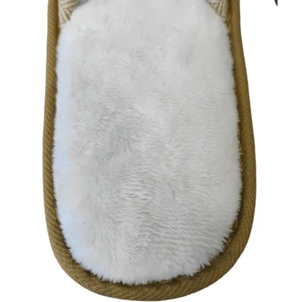 The Hotel Eco-friendly Slipper resting on a folded towel in a serene spa or wellness retreat, ready to provide natural comfort to guests.