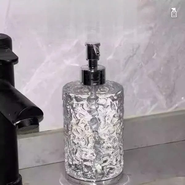 A Hand Sanitizer Dispenser Bottle beside a large bulk container, symbolizing the refillable system and reduced plastic waste.