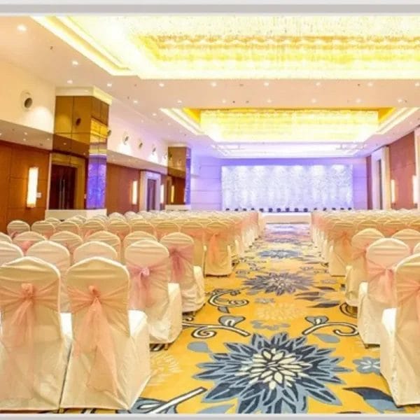 Stackable Hotel Banquet Chairs arranged around a large conference table for a corporate meeting setup.