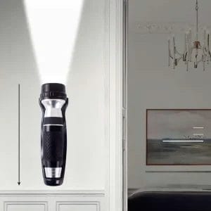 Black emergency torch mounted discreetly inside a wooden hotel wardrobe.