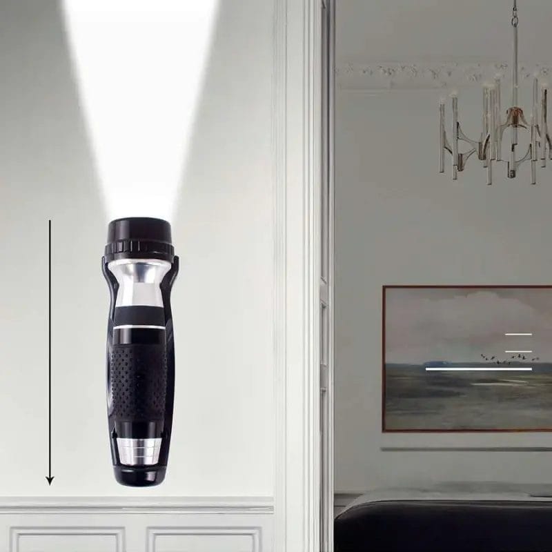 Black emergency torch mounted discreetly inside a wooden hotel wardrobe.