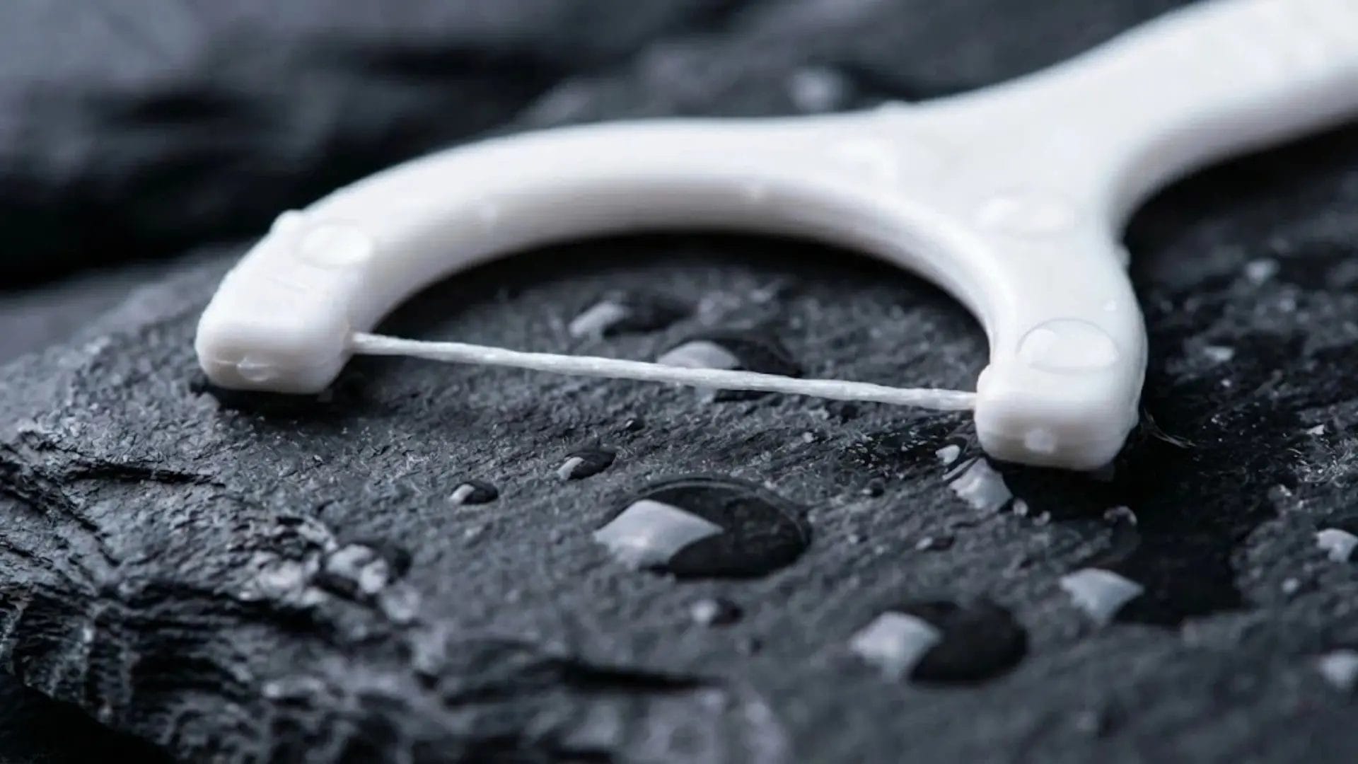 Close-up of high-tension dental floss pick for hotel dining comfort.