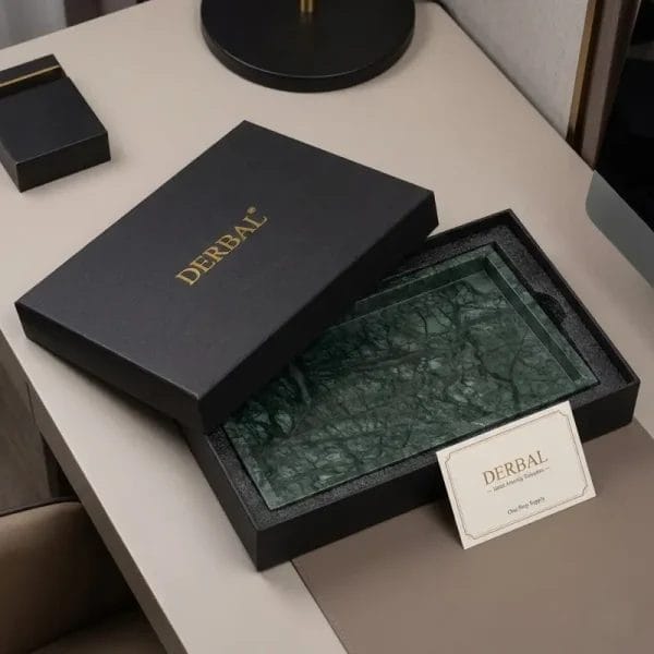 A Marble Vanity Tray with a matte, honed finish holding rolled towels and spa amenities.