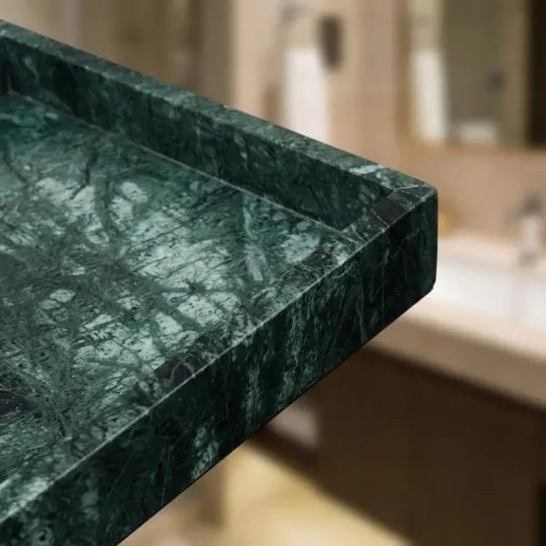 A Marble Vanity Tray styled on a dresser holding luxury perfumes, jewelry, and a candle.