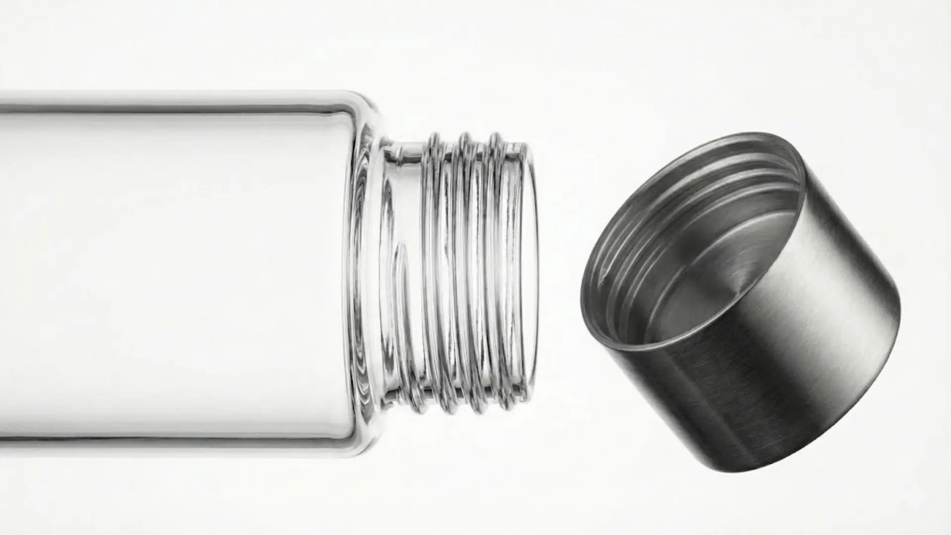 Close-up of a glass bottle neck threads and a brushed 304 stainless steel screw cap.