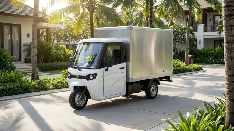 Professional white electric cargo tricycle with enclosed cab and aluminum box for resort logistics.
