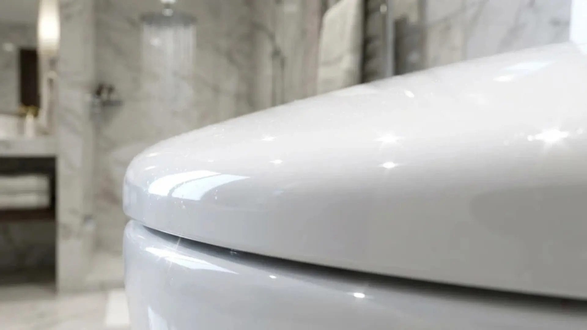 Close-up of a pristine, non-porous UF resin toilet seat surface representing high hygiene standards in hotels.