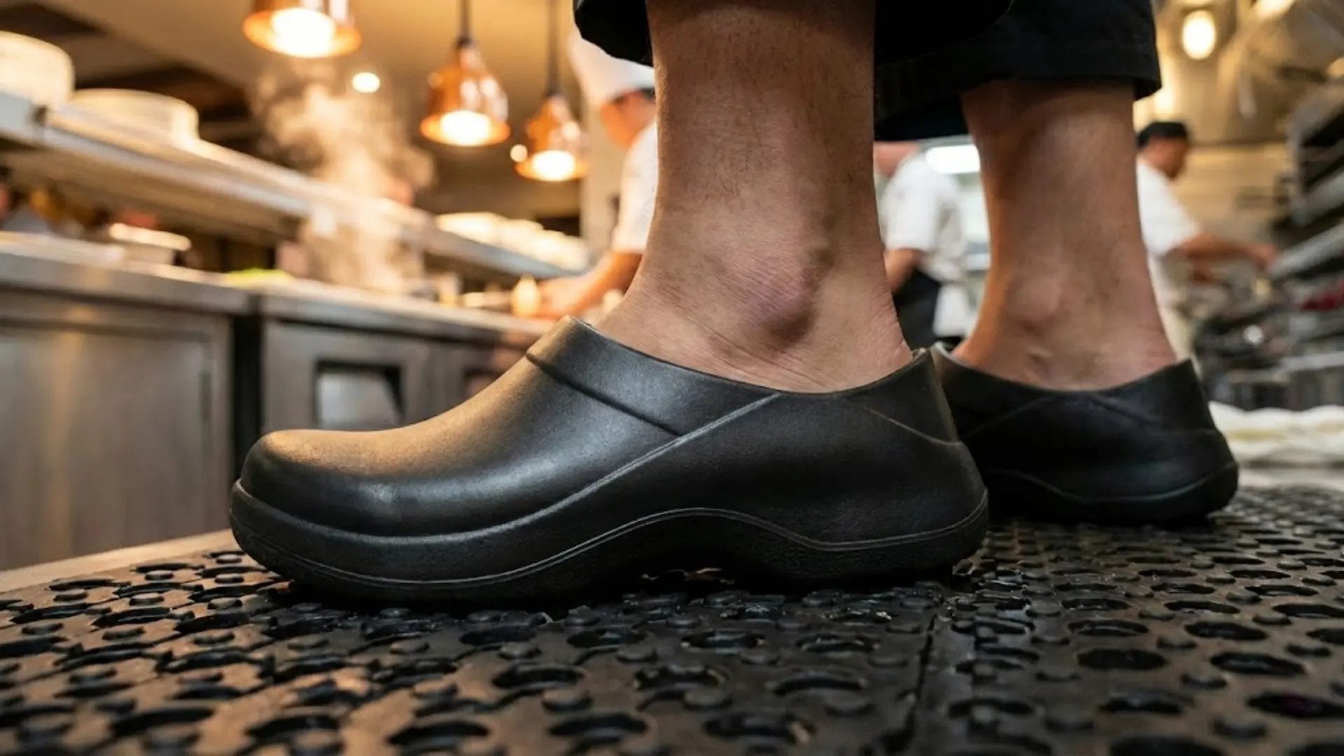 Close-up of ergonomic arch support in professional kitchen work shoes to reduce fatigue for staff standing all day.