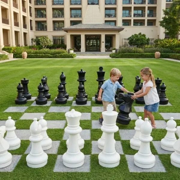 Grid display of giant fiberglass chess pieces including a white rook, black knight, green pawn, and blue queen, showing color customization options.