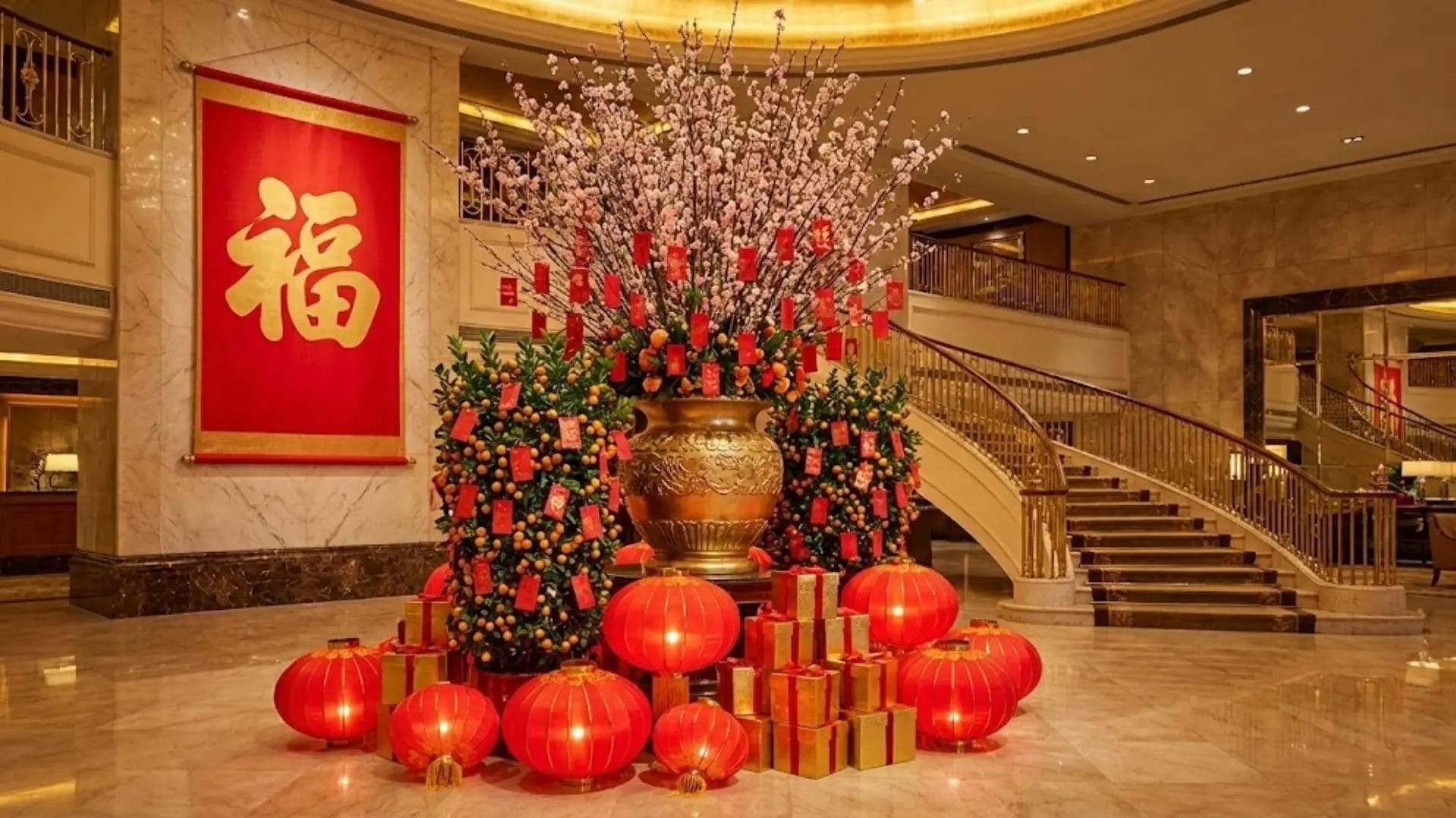 A opulent Chinese New Year centerpiece in a luxury hotel lobby, featuring cherry blossoms, kumquat trees, red lanterns, and gold decorations, creating a grand festive display.