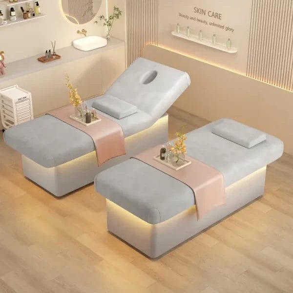 Two grey light luxury multifunctional spa massage beds with LED lighting in a modern beauty salon