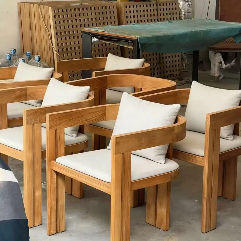 A macro close-up highlighting the rich, natural wood grain and smooth polyurethane lacquer finish of the solid Oak Dining Chair armrest.