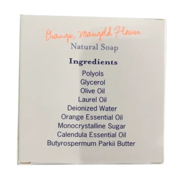 The soothing Orange and Marigold REJUVENATION Hotel Natural Soap resting on a wooden bath tray beside a luxurious freestanding resort bathtub.