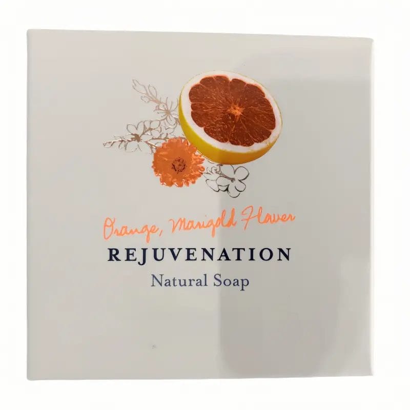 A beautifully wrapped Orange and Marigold REJUVENATION Hotel Natural Soap displayed elegantly on a luxury resort marble vanity.